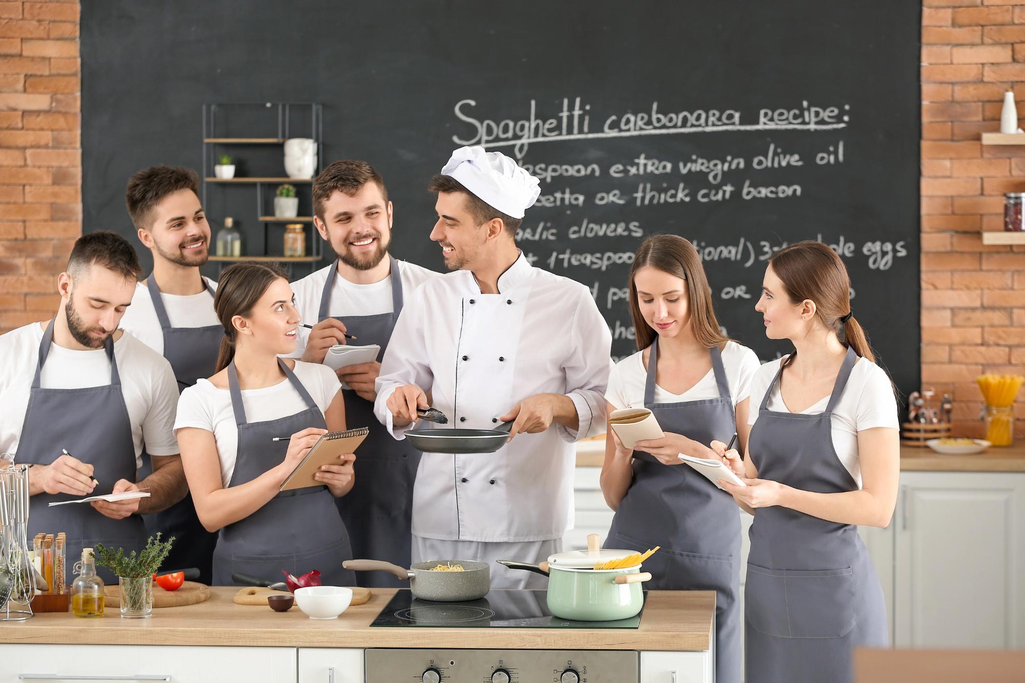 A cooking class scene with a chef demonstrating how to make spaghetti carbonara, surrounded by enthusiastic students taking notes and preparing ingredients.