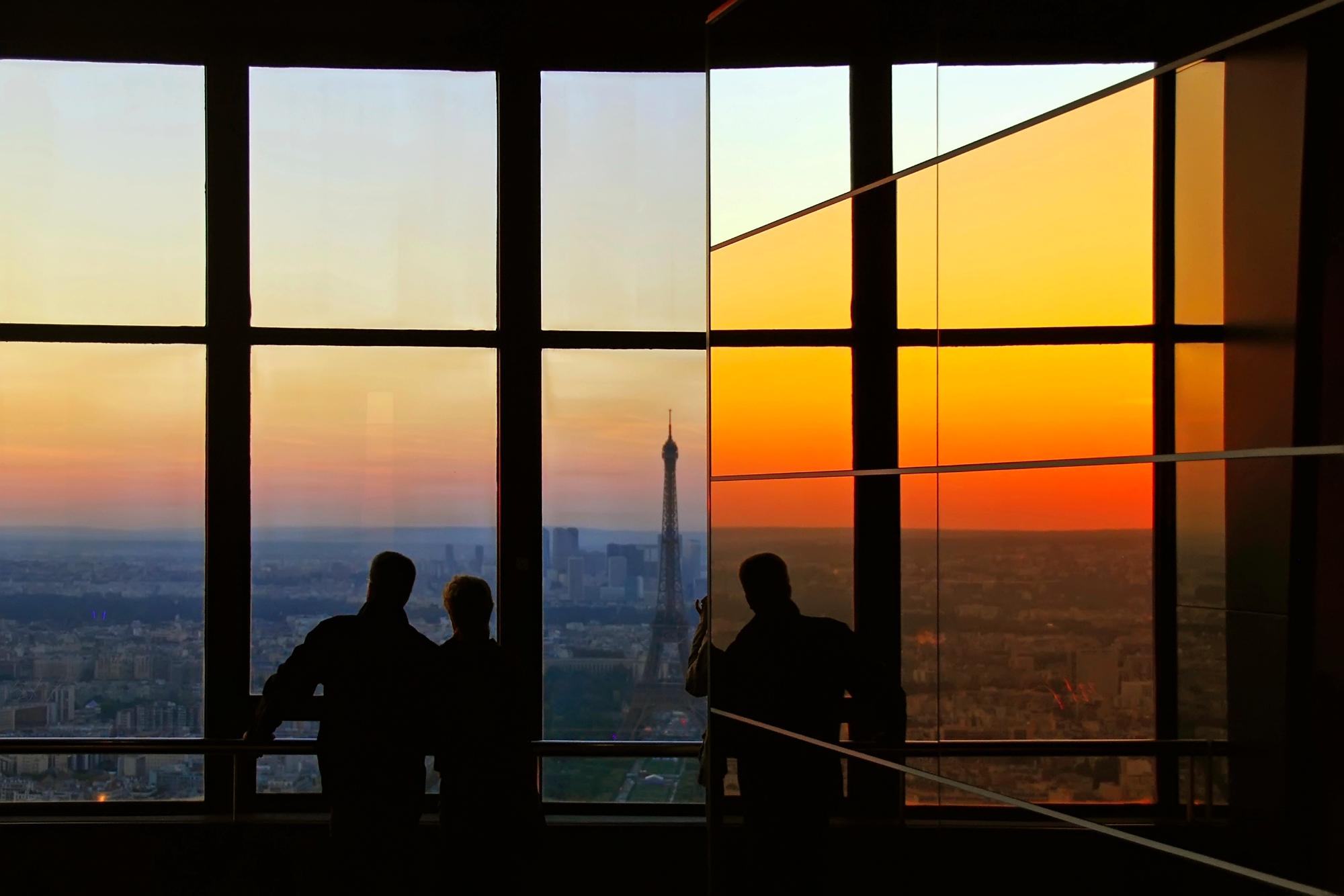Silhouette of a couple admiring the sunset view of Paris with the Eiffel Tower from the Montparnasse building