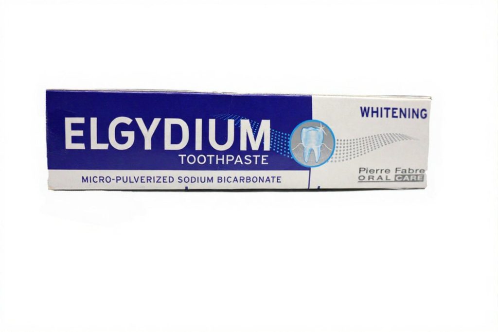 Elgydium Whitening Toothpaste box featuring micro-pulverized sodium bicarbonate for oral care.