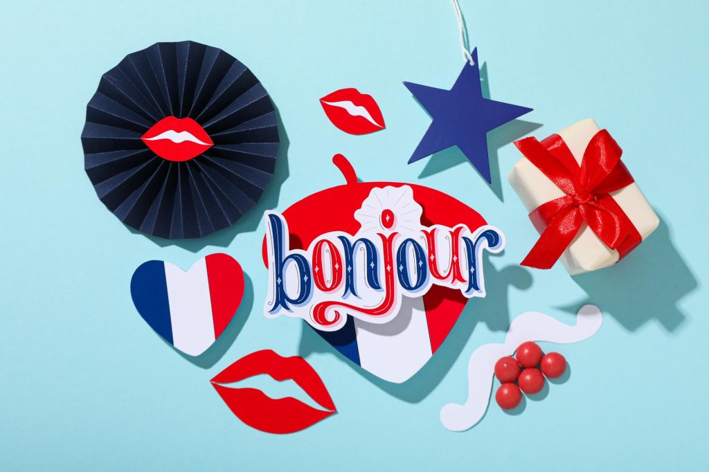 A collection of decorative items featuring the French flag, lips, a star, and the word 'bonjour' against a blue background.
