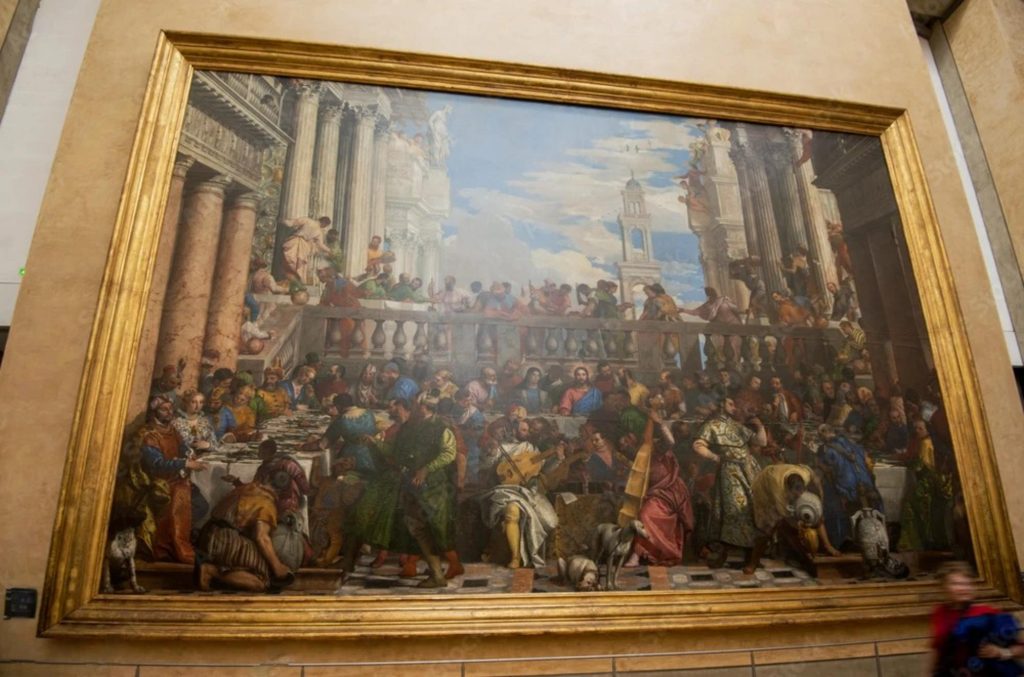 A detailed depiction of 'The Wedding at Cana' by Paolo Veronese showing a grand banquet with many figures in historical clothing, set in an ornate architectural background.