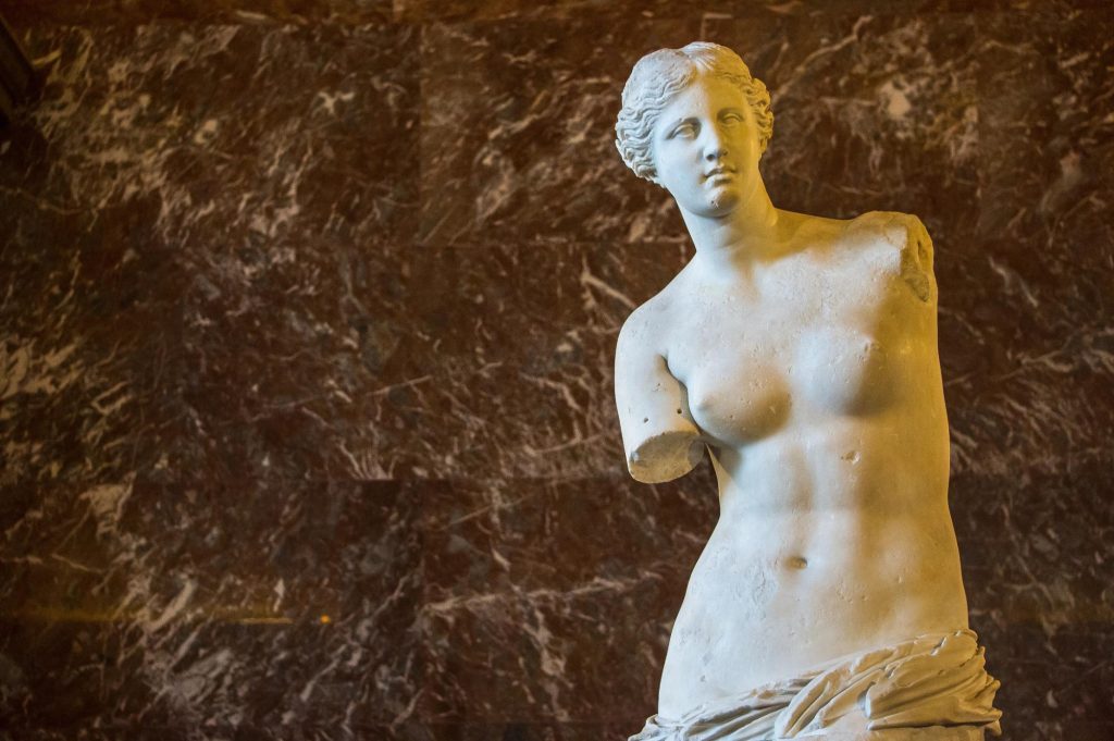 The Venus de Milo is an ancient Greek statue representing the goddess of love and beauty, notable for its missing arms and intricate drapery.
