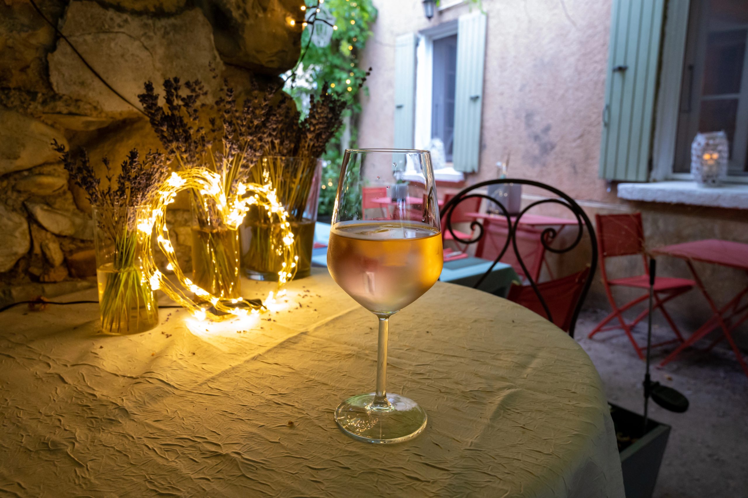 Summer night on French Riviera Cote d'Azur, drinking cold rose wine from Cotes de Provence on outdoor terrase in old cafe, Var, France