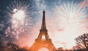 Holiday background - Eiffel tower with fireworks, celebration of the New Year in Paris, France