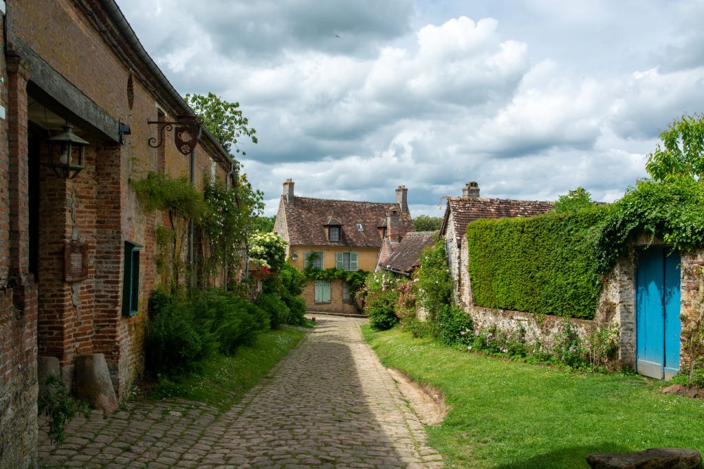Tourist destination, one of most beautiful french villages, Gerberoy - small historical village with half-timbered houses and colorful roses flowers, France 