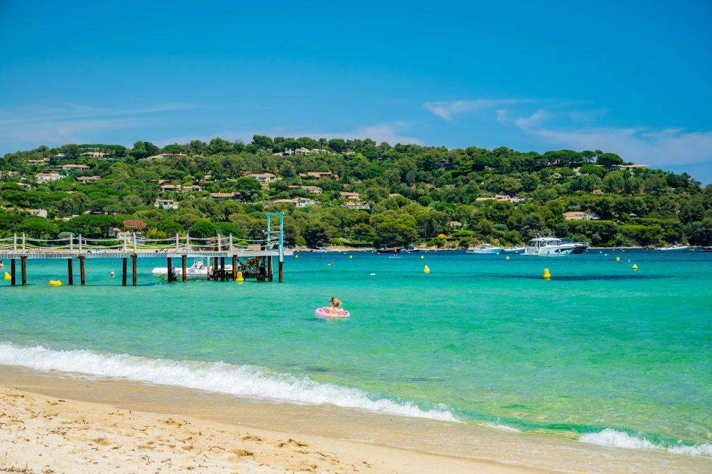 Crystal clear blue water of legendary Pampelonne beach near Saint-Tropez, summer vacation on white sandy beach of French Riviera, France
