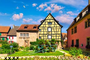 Traditional timbered house in Turckheim, Alsace, France. One of the famous cities in Alsace scenic route near Colmar, France. Colorful traditional french houses in Turckheim town of Alsace, France.