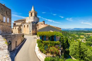 View of Venasque village with old church Notre Dame de Vie to landscape of Luberons, Provence, France.