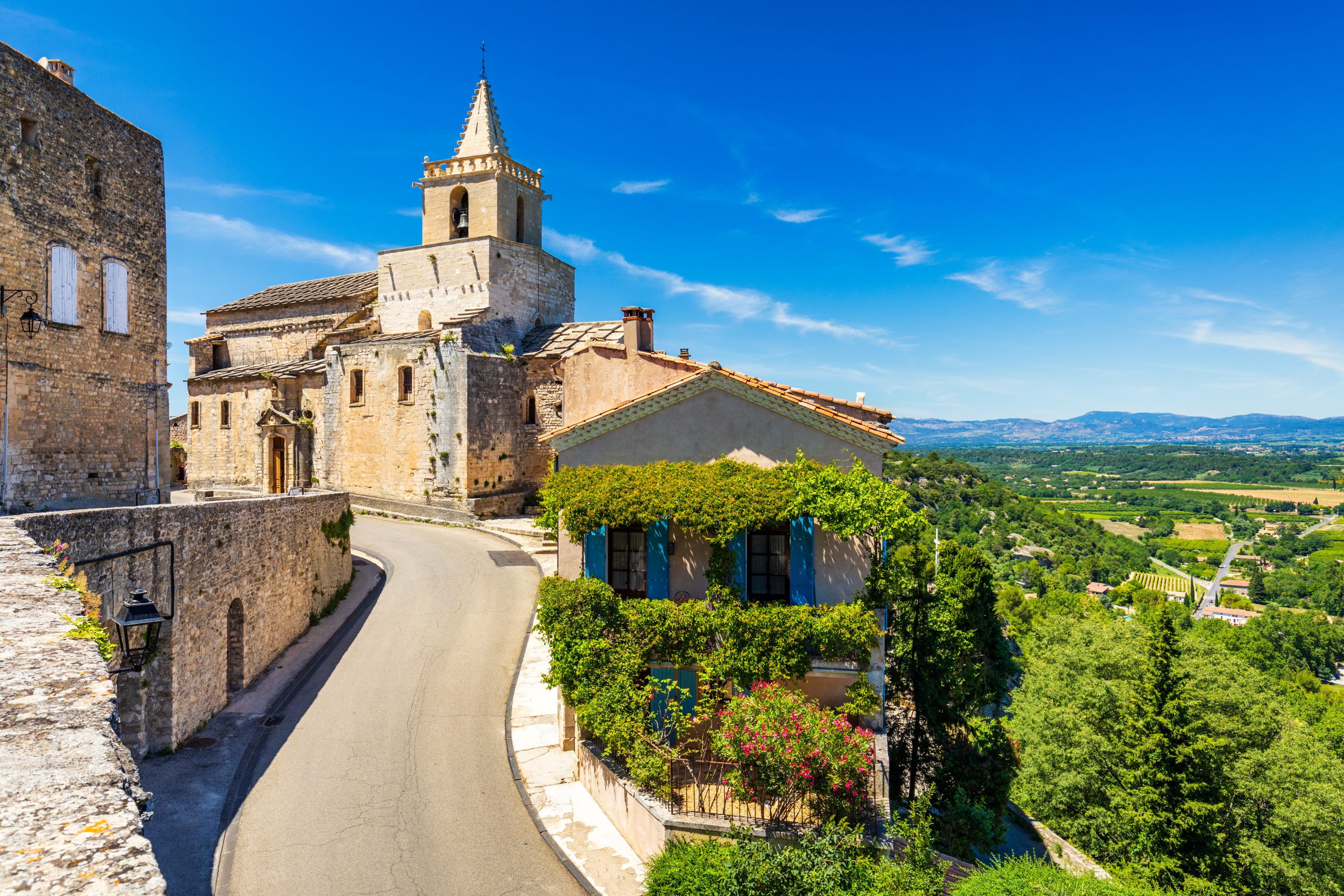 View of Venasque village with old church Notre Dame de Vie to landscape of Luberons, Provence, France.