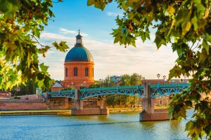 Vibrant landscape at sunset along the Garonne River and La Grave dome in Toulouse, France