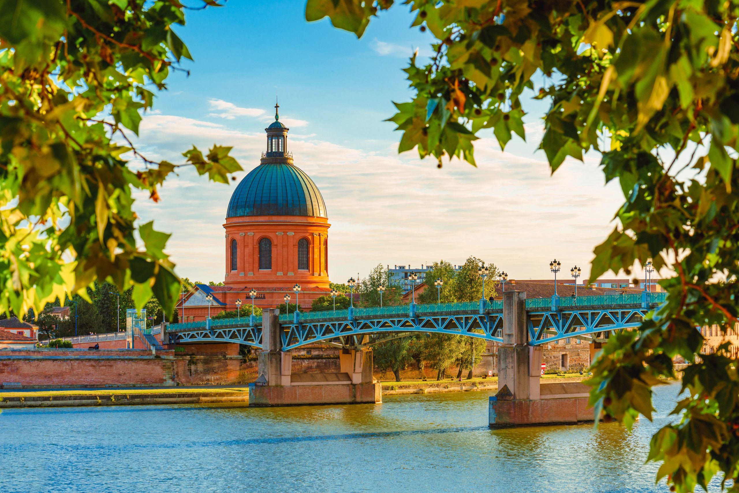 Vibrant landscape at sunset along the Garonne River and La Grave dome in Toulouse, France